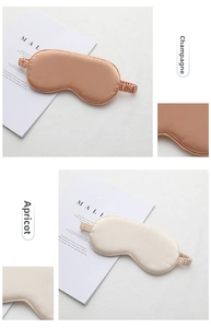 Detail of champagne and apricot satin silk sleep masks with elastic headbands