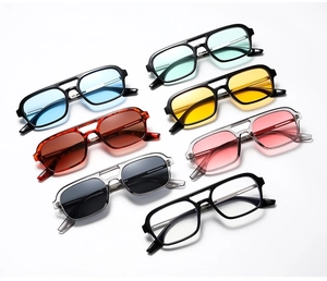 Flat lay of retro sunglasses with double bridge frames in multiple lens colors and patterns