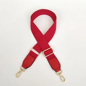 Adjustable red canvas shoulder strap with gold metal lobster clasps for handbags