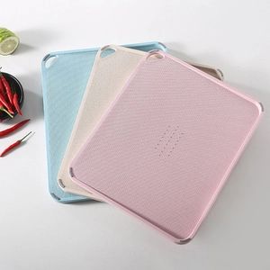 Three-piece wheat straw cutting board set in pink, beige, and blue with grinding area