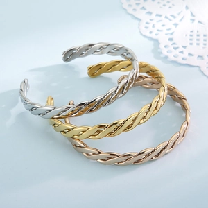 Twisted stainless steel bangles set in gold, silver, and rose gold finishes
