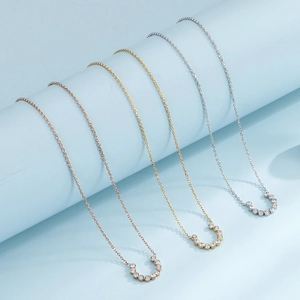 Three-piece horseshoe diamond necklace set in silver, gold, and rose gold finishes