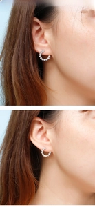 Close-up of sparkling C-shaped stud earrings with pavé set cubic zirconia on model