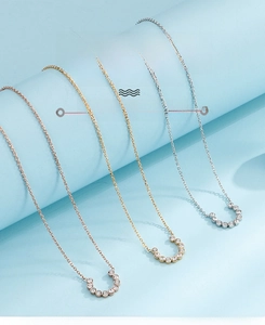 Detailed view of C-shaped necklaces with zircons in rose gold, gold, and silver finishes