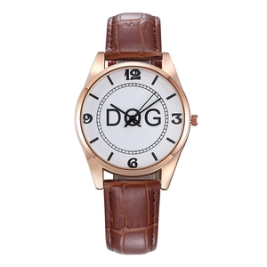 Detail of rose gold watch case with brown alligator leather strap and large Arabic numerals