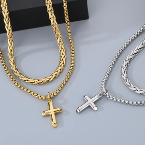 Detailed view of gold and silver layered Cuban chains with cross pendants