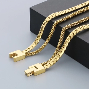 Macro detail of gold layered chain necklace with a secure square mechanical clasp