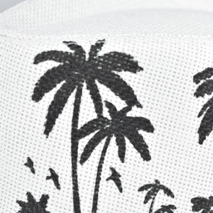 Close-up of white linen sun hat featuring detailed black coconut palm tree patterns