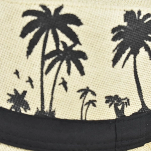 Macro shot of breathable linen sun hat fabric featuring black palm tree prints