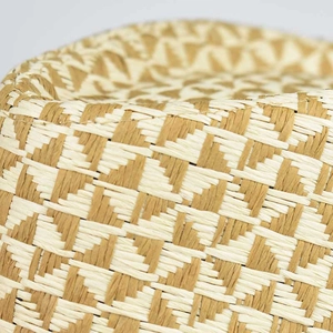 Macro view of bicolor linen fedora hat featuring a detailed geometric woven pattern