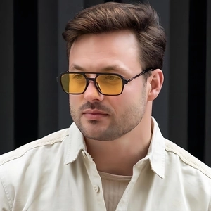 Detail of vintage aviator sunglasses with black double bridge frame and yellow lenses