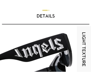 Macro detail of gothic style metal Angels text on black sunglasses temples