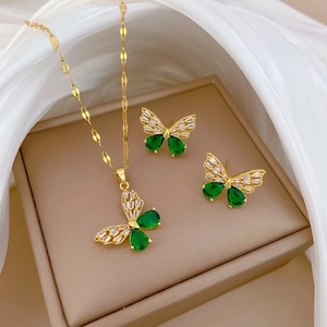 Elegant gold butterfly jewelry set including necklace and earrings with green stones