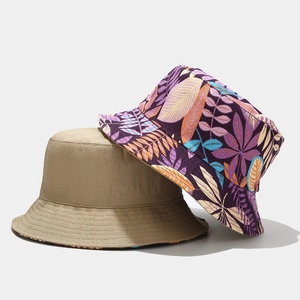 Women reversible canvas bucket hat featuring solid khaki and tropical floral print patterns