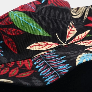 Detailed close-up of tropical leaf print and double stitching on black canvas bucket hat