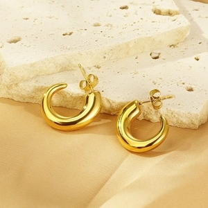 Elegant 18K gold plated stainless steel C-shape earrings on neutral textured stone