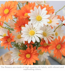 Close-up of silk daisy petals and realistic yellow stamens in orange and white colors