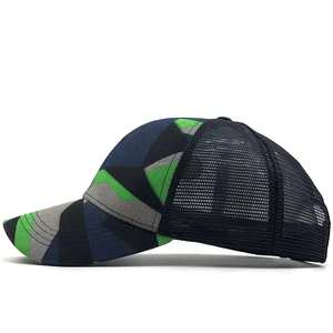 Detail of patchwork mesh trucker hat with camouflage pattern and breathable black mesh