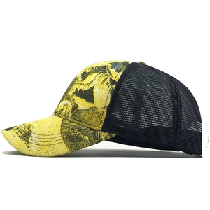 Detail of yellow and black graffiti print with breathable mesh back on trucker hat
