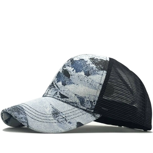 Detail view of tie-dye canvas brim and breathable black mesh on the back of trucker hat