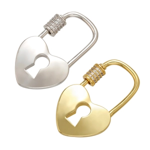 Detail of silver and gold heart-shaped padlocks with inlaid micro-diamonds on white background