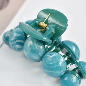 Large teal marble resin shark hair claw clip for women with golden metal spring detail