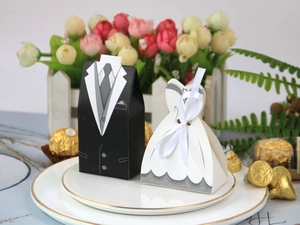 European wedding favor boxes with groom suit and bridal gown designs on a porcelain plate