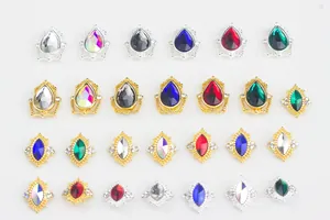 Detailed view of marquise and pear shaped nail charms with assorted colorful gemstones