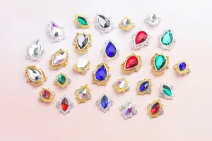 Macro shot of colorful teardrop and marquise nail rhinestones in ornate alloy settings