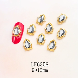 Detailed retro teardrop nail art charms with grey stones and crystals on gold alloy base