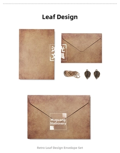 Detail of vintage stationery set with kraft paper envelope and bronze leaf pendants
