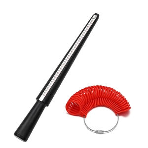 Detail of red finger sizing gauges and black ring mandrel showing US and UK size scales