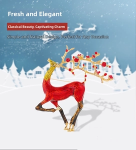 Detail of red enamel elk brooch with gold antlers and floral accents for Christmas