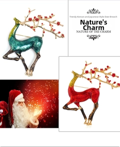 Detail of Christmas elk brooch pins with green and red enamel and floral branch antlers