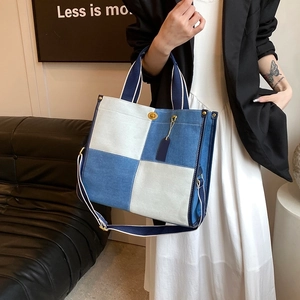 Detailed close-up of canvas contrast tote bag with blue and white checkered pattern details