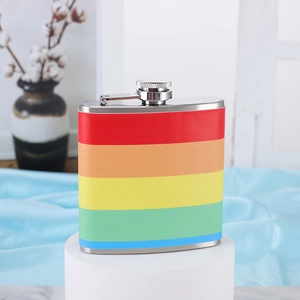 Close-up of rainbow striped 6oz stainless steel hip flask on a white display stand