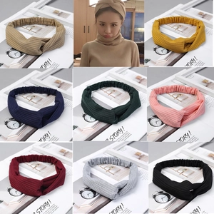Macro detail of elastic ribbed knit headbands in eight colors with stylish twist knot design