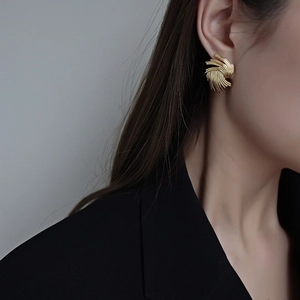 Exaggerated golden titanium steel ear studs with textured 18K spiral wing design