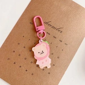 Detail of pink acrylic bear charm with strawberry hat and sturdy metal lobster clasp