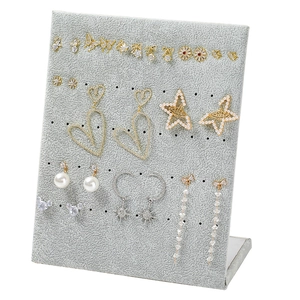 Grey velvet L-shaped jewelry display stand featuring assorted gold and silver earrings