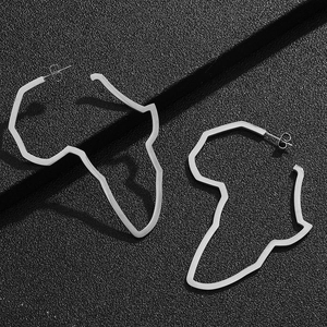 Detailed view of silver Africa map silhouette hoop earrings on a black leather background