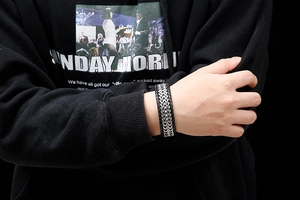 Nahaufnahme eines Herrenarmbandes aus schwarzem Leder und silbernem Edelstahl