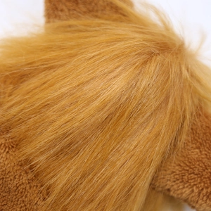 Macro view of plush golden-brown faux fur texture showing soft fluffy dog costume fabric