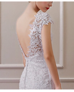 Detail view of exquisite lace appliqués on the elegant open-back mermaid wedding gown