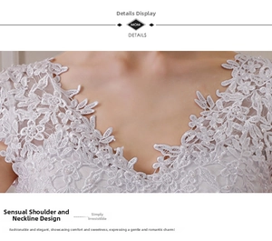 Detailed close-up of white floral lace neckline with delicate pearls and sequins