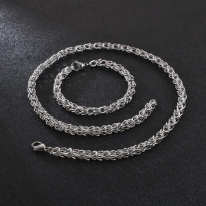 Polished silver stainless steel crown necklace and bracelet set in braided chain design