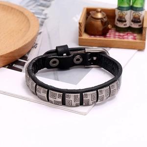 Macro shot of punk black leather bracelet with silver rivets and adjustable buckle