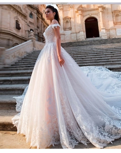 Detailed view of luxury bridal gown featuring intricate lace embroidery and long train
