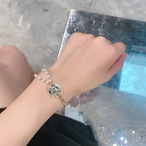 Minimalist asymmetrical gold coin bracelet for women with white pearls and metal chain