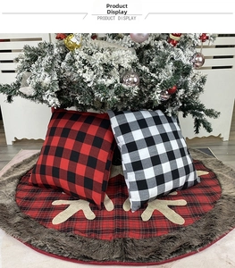 Detail of red buffalo plaid Christmas tree skirt with plush trim and reindeer pattern